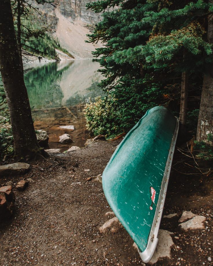 a canoe sitting on the shore of a lake