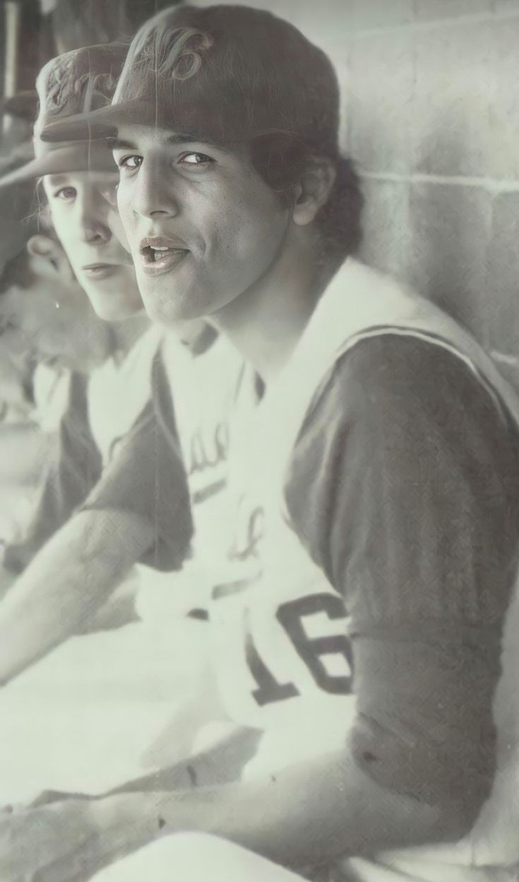 two baseball players sitting next to each other