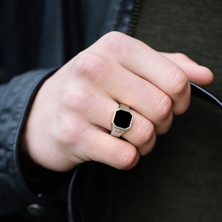 This rhodium-plated 925s silver ring for men features a black onyx stone. The maker's logo is neatly etched on 1 side. Makes a great gift for the stylish man. Gift pouch is included. Dad Ring, Onyx Ring Men, Onyx Signet Ring, Mens Rings Fashion, Silver Ring Designs, Mens Rings, Black Onyx Stone, Stainless Steel Ring, Ring Black