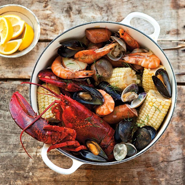 a pot filled with seafood and corn on the cob