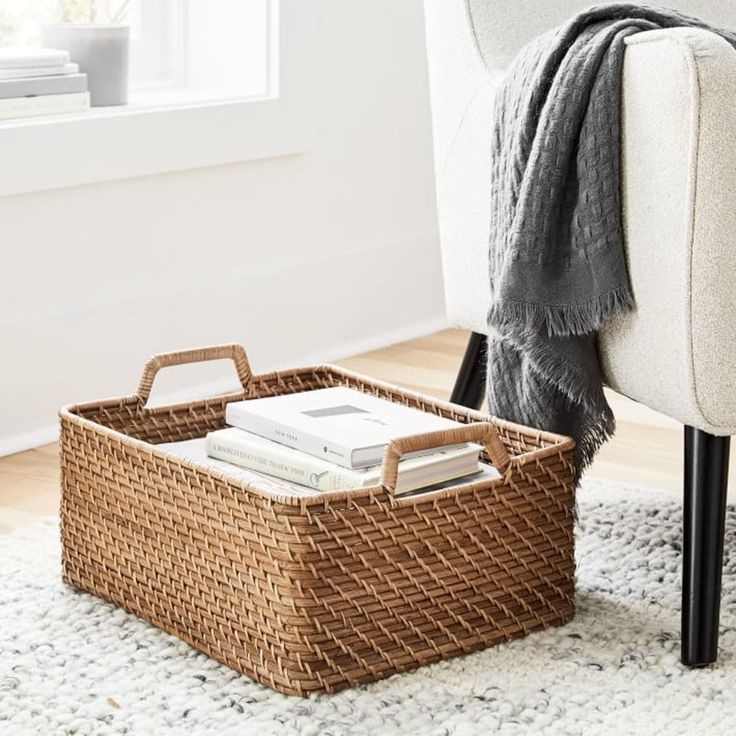 a wicker basket sitting on top of a rug next to a chair