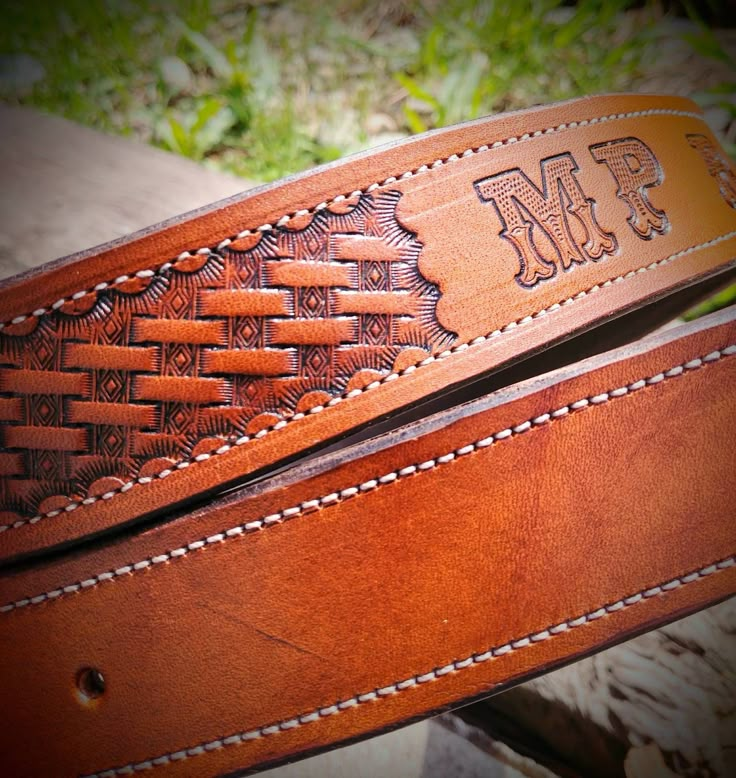 a leather belt with the initials mr and mrs engraved on it's center strip