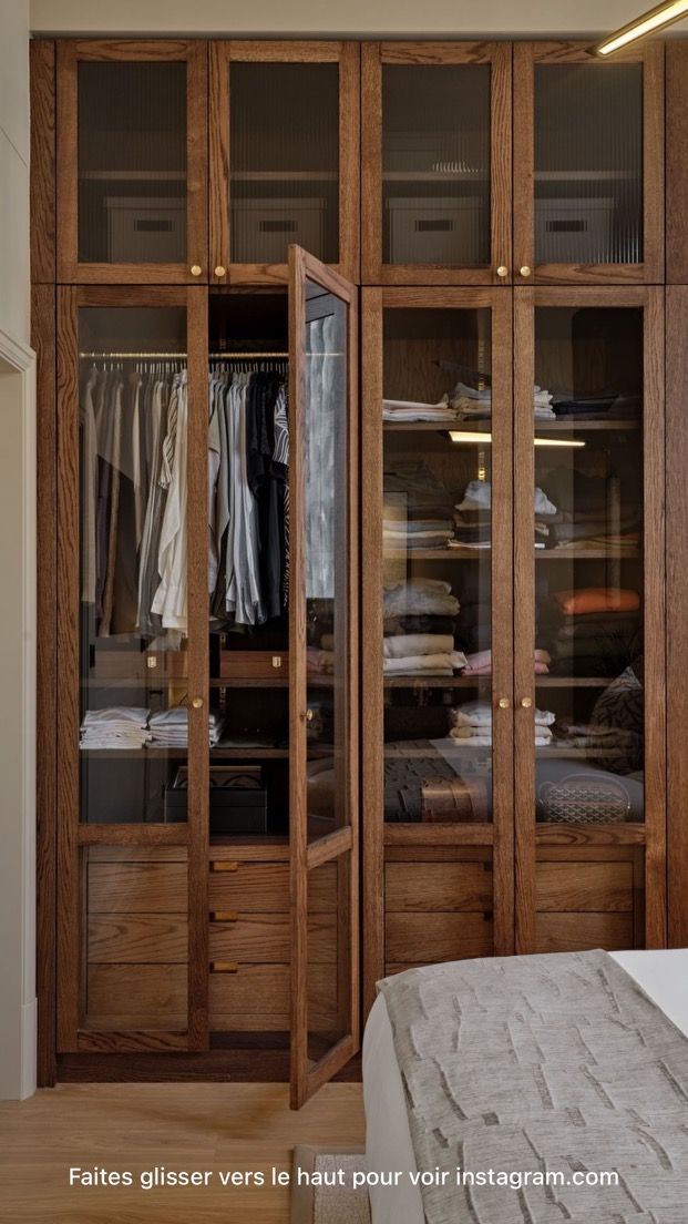 an image of a bedroom setting with closets and clothes on the shelves in it