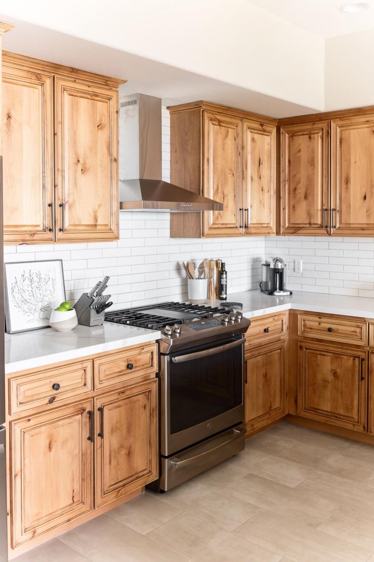 a kitchen with wooden cabinets and stainless steel appliances