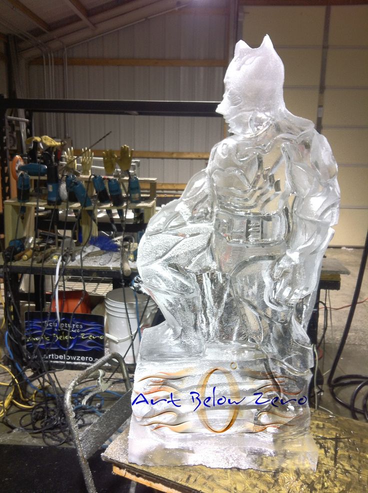 an ice sculpture sitting on top of a table in a room filled with other items