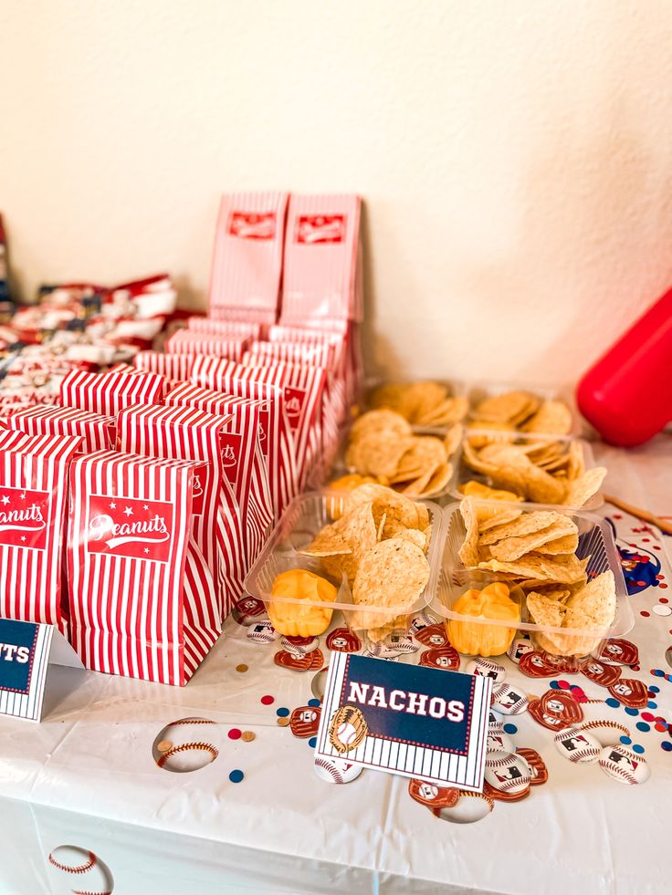 some snacks are on a table with red and white striped bags