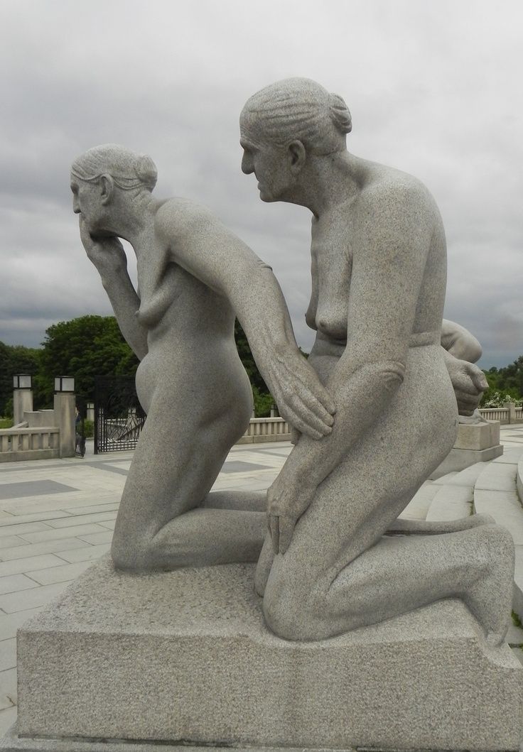 there is a statue that looks like a woman holding a child in her lap and sitting on the ground