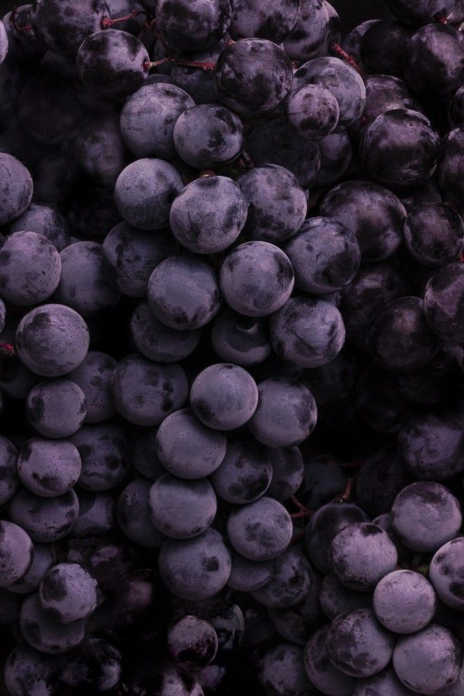 a bunch of blueberries are piled up together