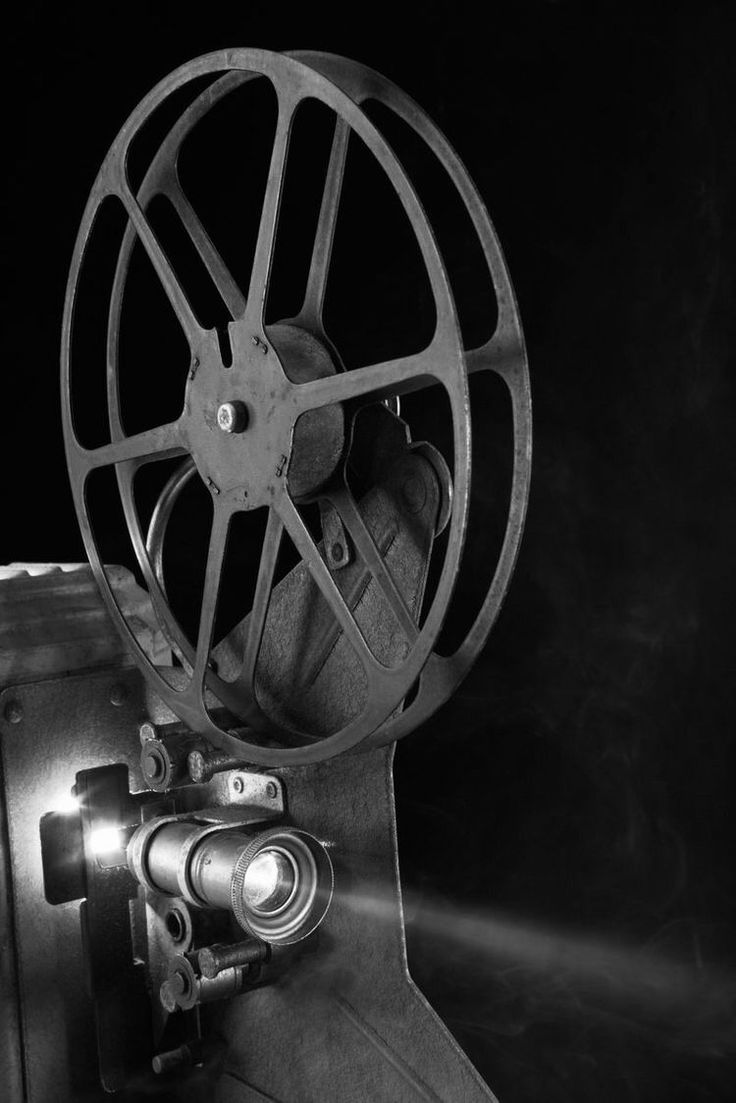 a black and white photo of a movie projector