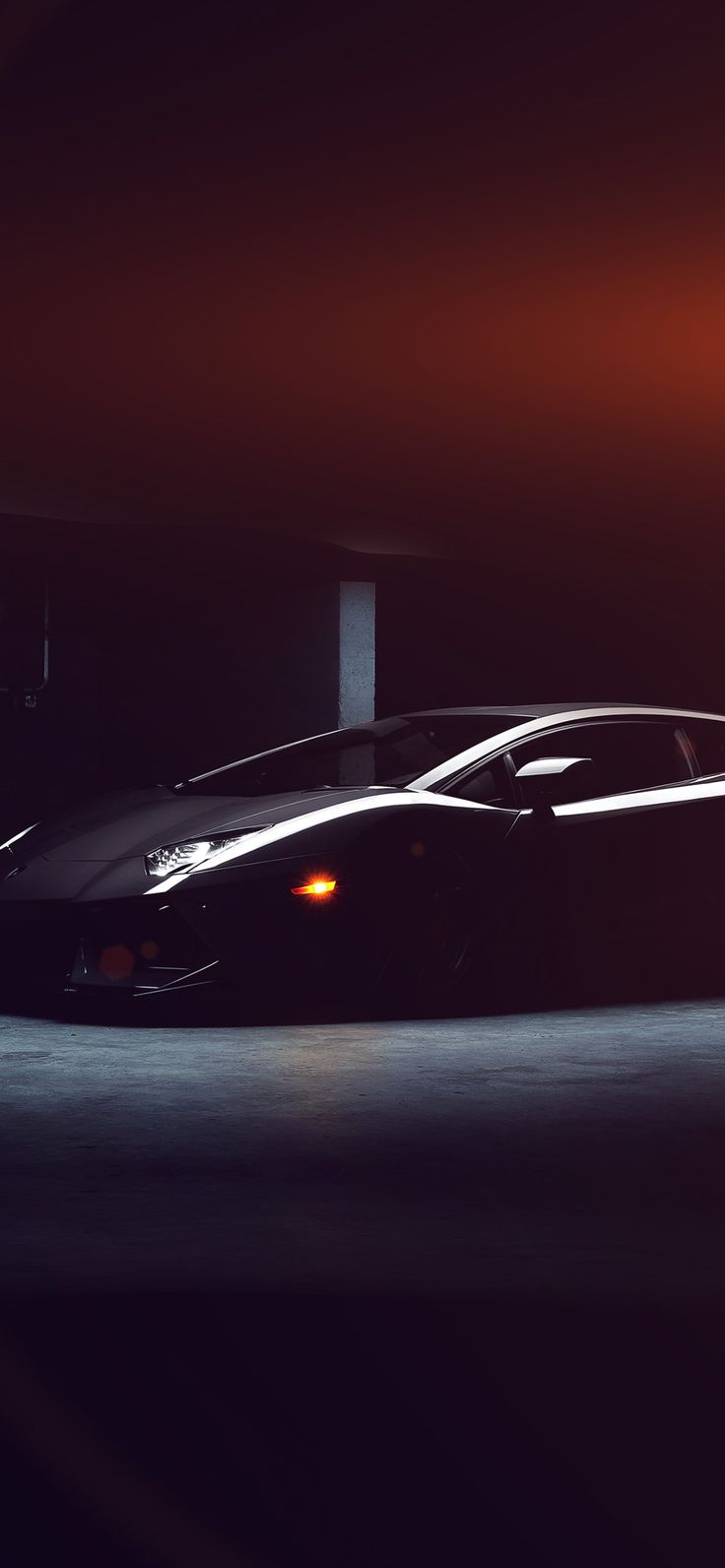 a black sports car is parked in the dark