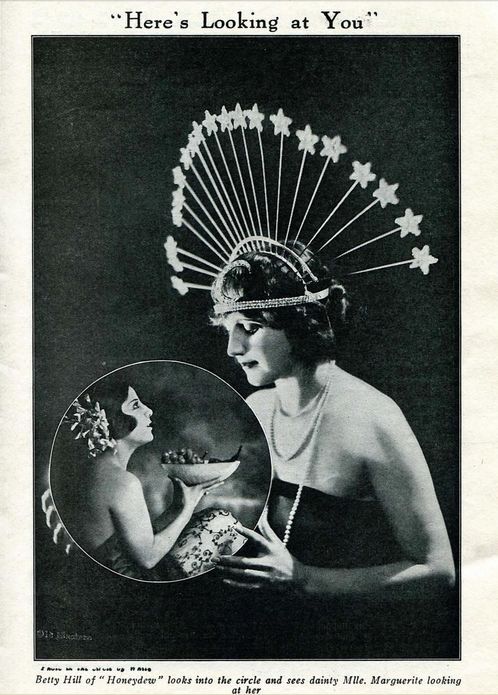 an old advertisement with a woman wearing a headdress and holding a fan in her hand