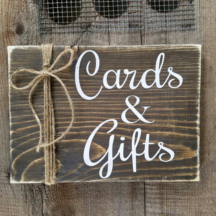 a wooden sign that says cards and gifts