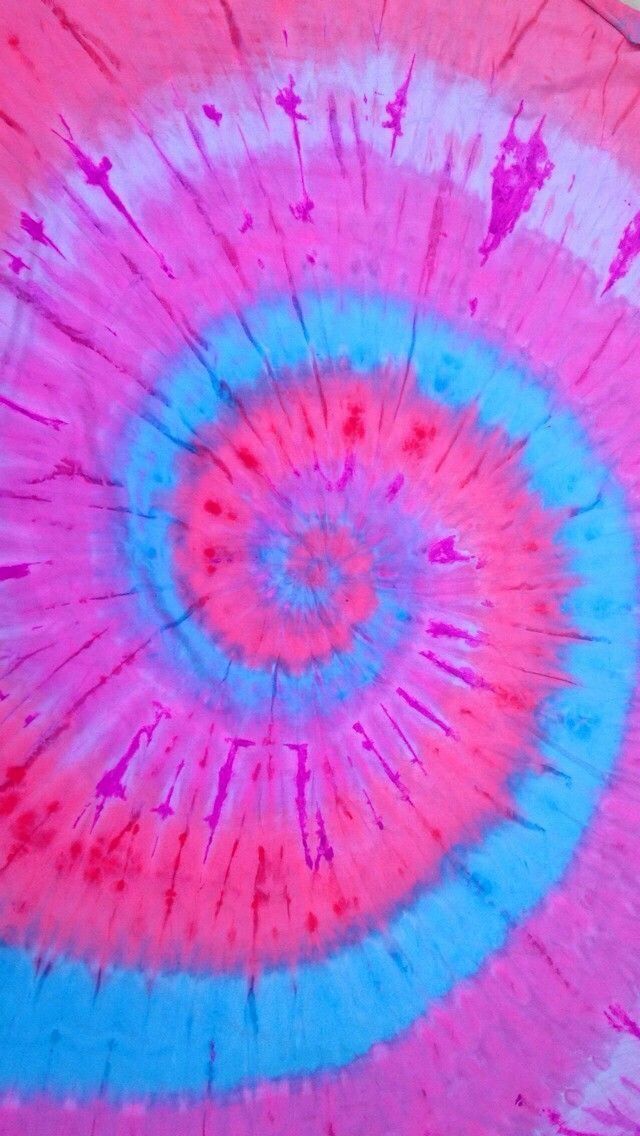 a pink and blue tie - dyed umbrella is seen in this close up photo,