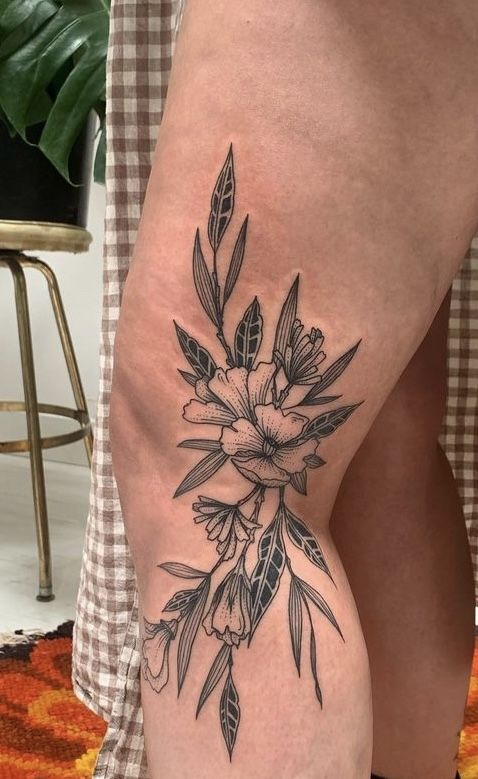 a woman's thigh with flowers on it