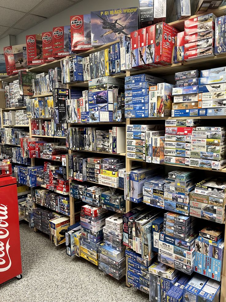 a store filled with lots of different types of items and boxes on shelves next to each other