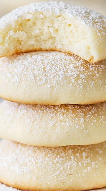 three sugar cookies stacked on top of each other with powdered sugar on the edges