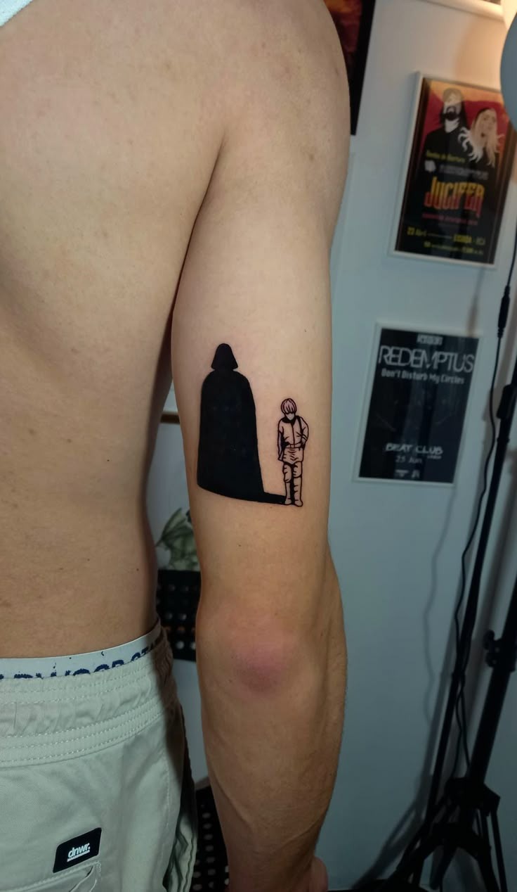 a man's arm with a small tattoo of an astronaut and a rocket ship