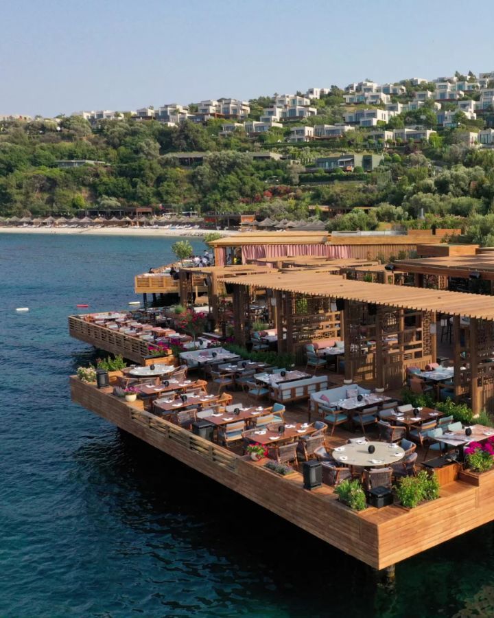 an aerial view of a restaurant on the water