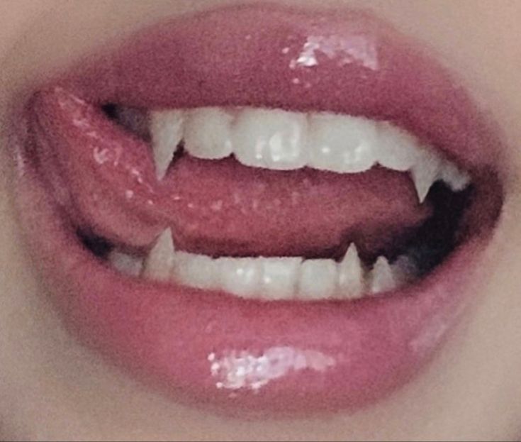 a woman's mouth with white teeth and pink lipstick