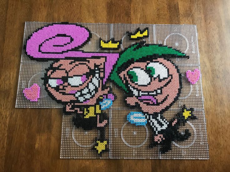 two pixellated images of cartoon characters on a wooden floor, one is pink and the other is green