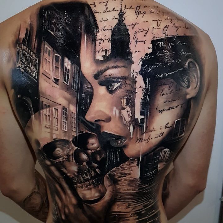 a man's back is covered in black and white tattoos, with an image of two