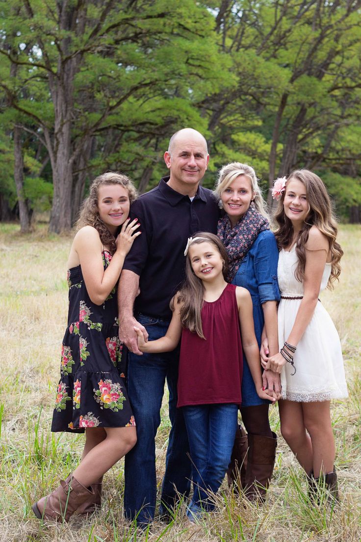 a family posing for a photo in the grass