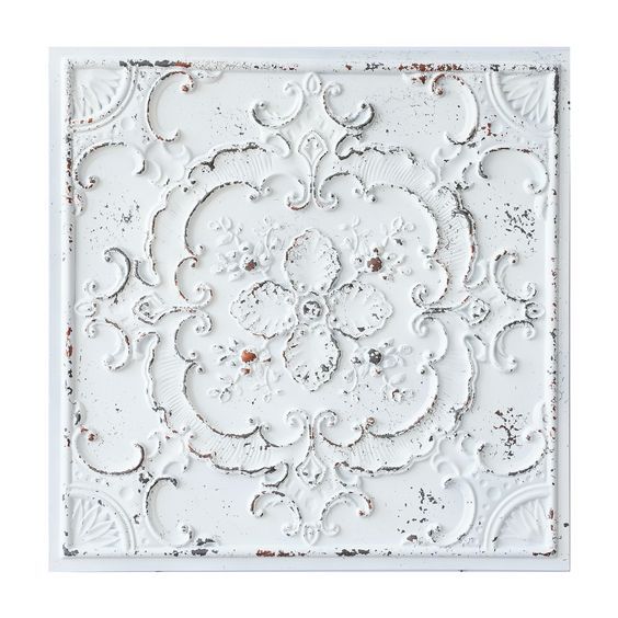 an old white wall panel with ornate designs