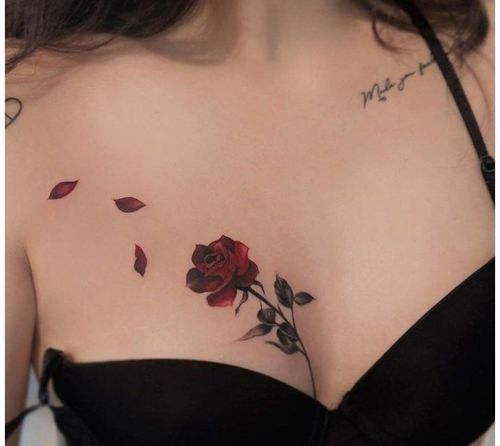 a woman with a rose tattoo on her chest