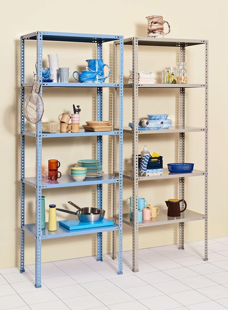 two shelving units with various items on them in a room that appears to be empty