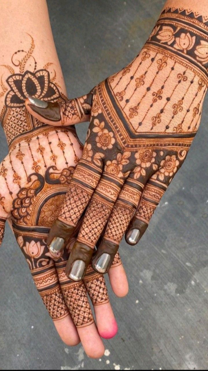 two hands with henna designs on them