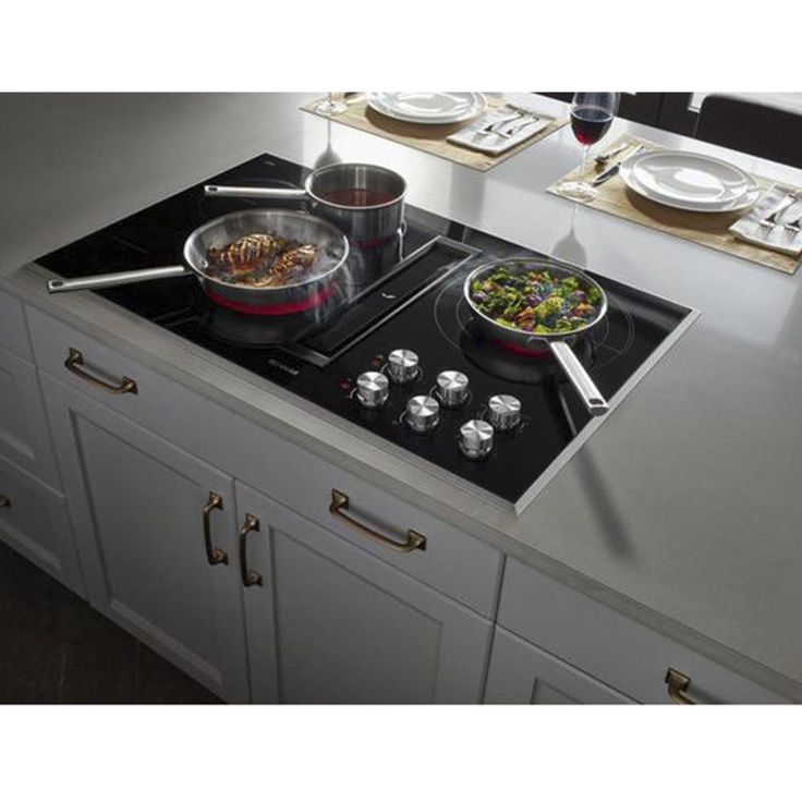 a stove top with two pans on it