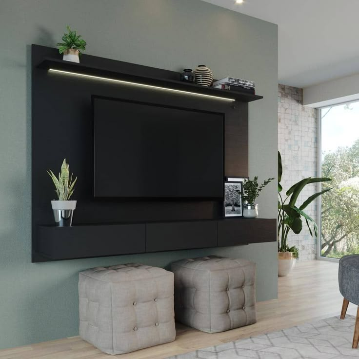 there is a tv on the wall in the living room with two stools next to it