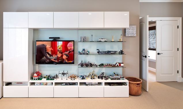 a living room filled with furniture and a flat screen tv on top of a wall