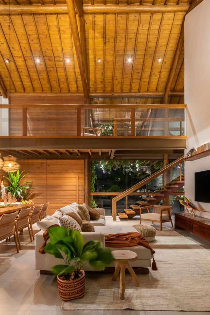 a living room filled with furniture and a flat screen tv on top of a wooden wall