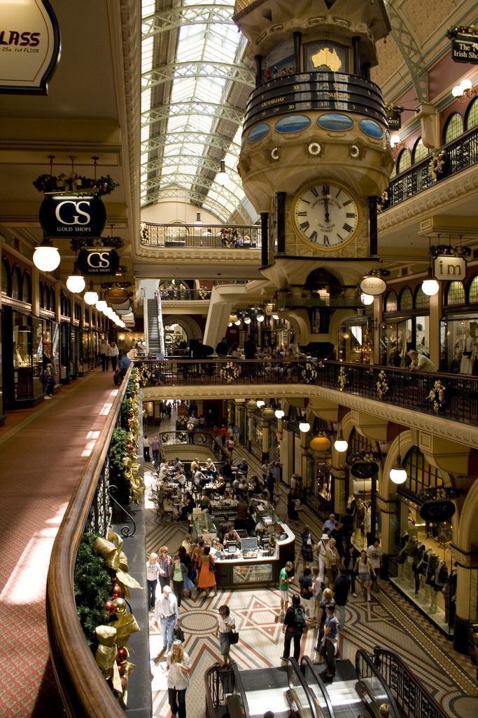 the inside of a shopping mall with people walking around