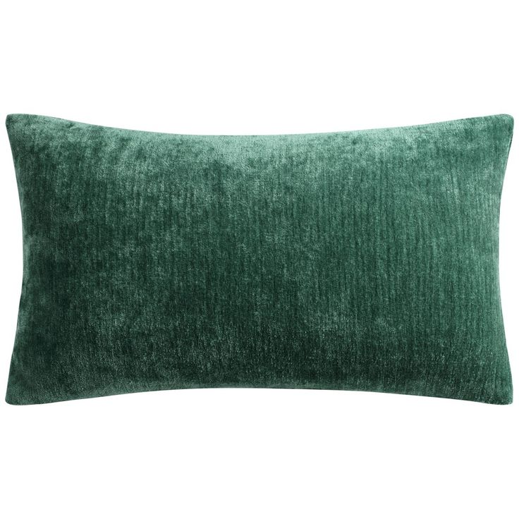 a green velvet pillow on a white background