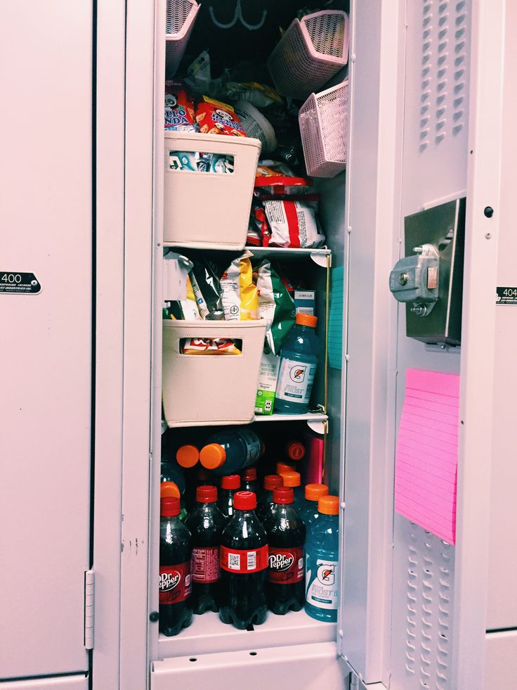 an open refrigerator filled with lots of food and drinks next to a pink post - it note