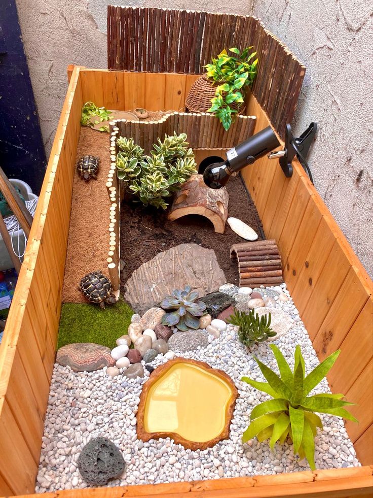 a wooden box filled with rocks and plants