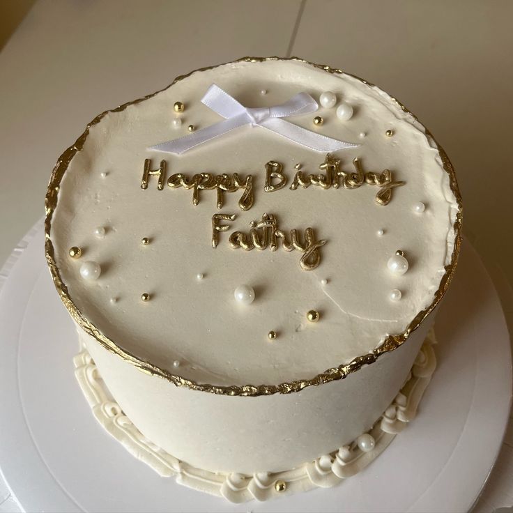 a birthday cake with white frosting and gold trimmings that says happy birthday family