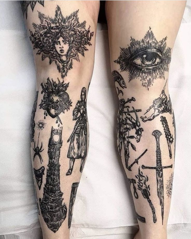 a person with tattoos on their legs laying in bed next to an eye and other items