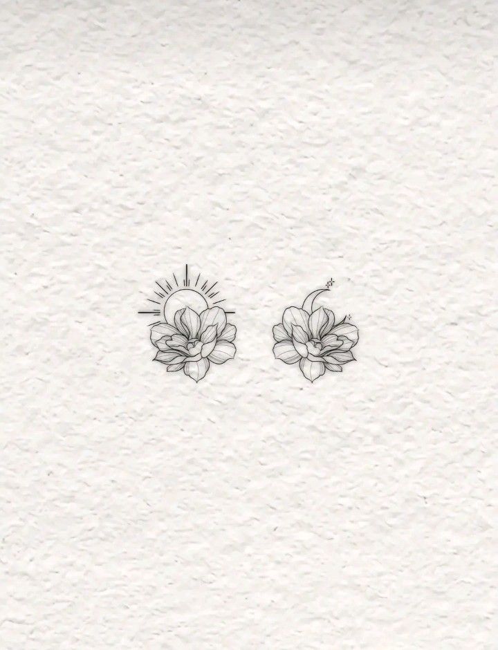 two small flowers are drawn on paper