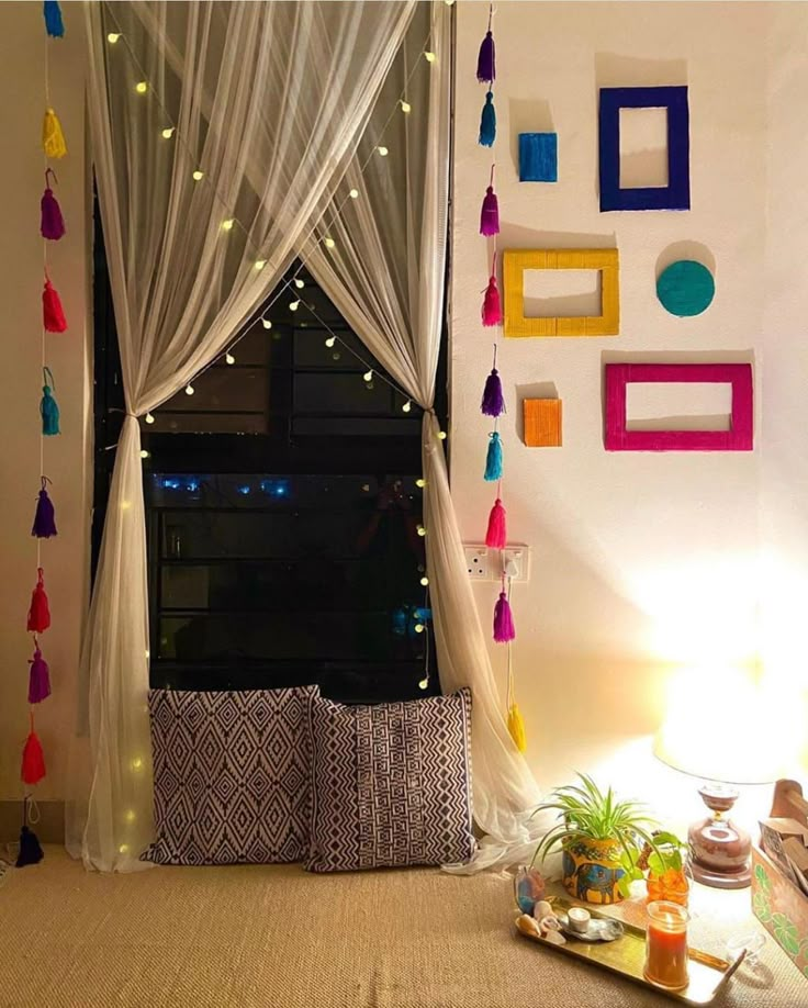 a living room filled with lots of furniture next to a window covered in white curtains