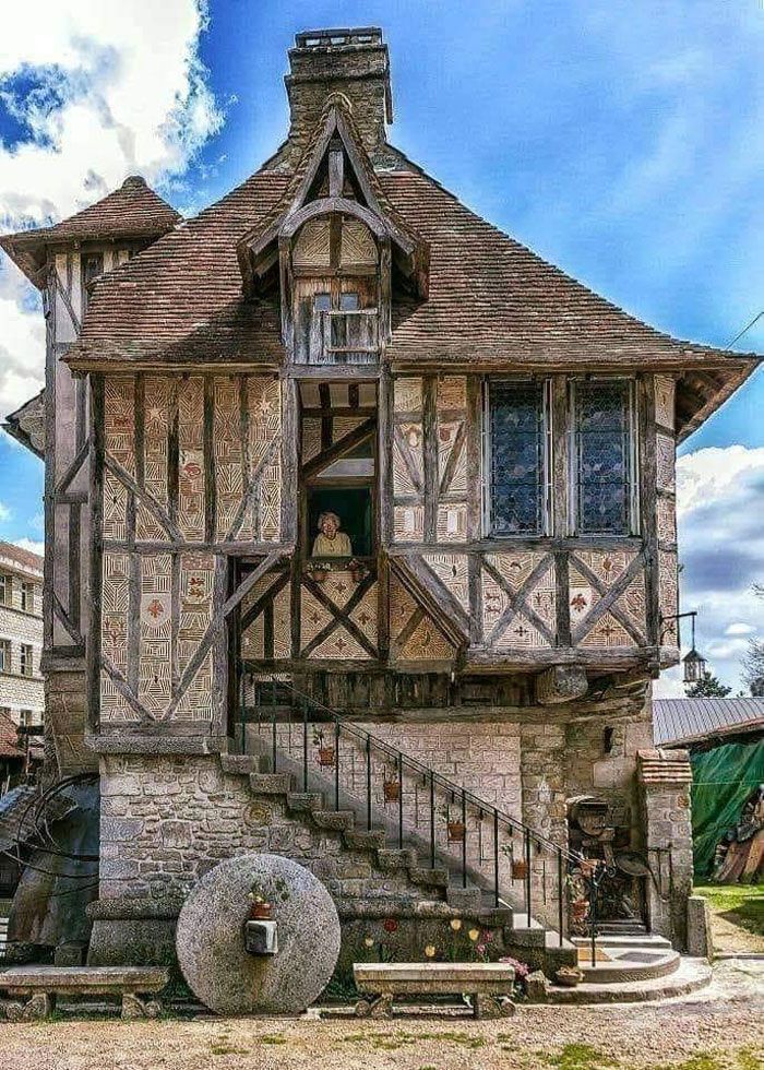 an old style house with stairs leading up to it