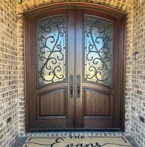 the front door is decorated with a welcome mat