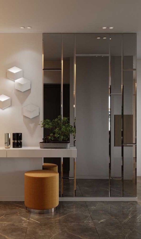 a modern bathroom with marble flooring and white walls, along with mirrors on the wall