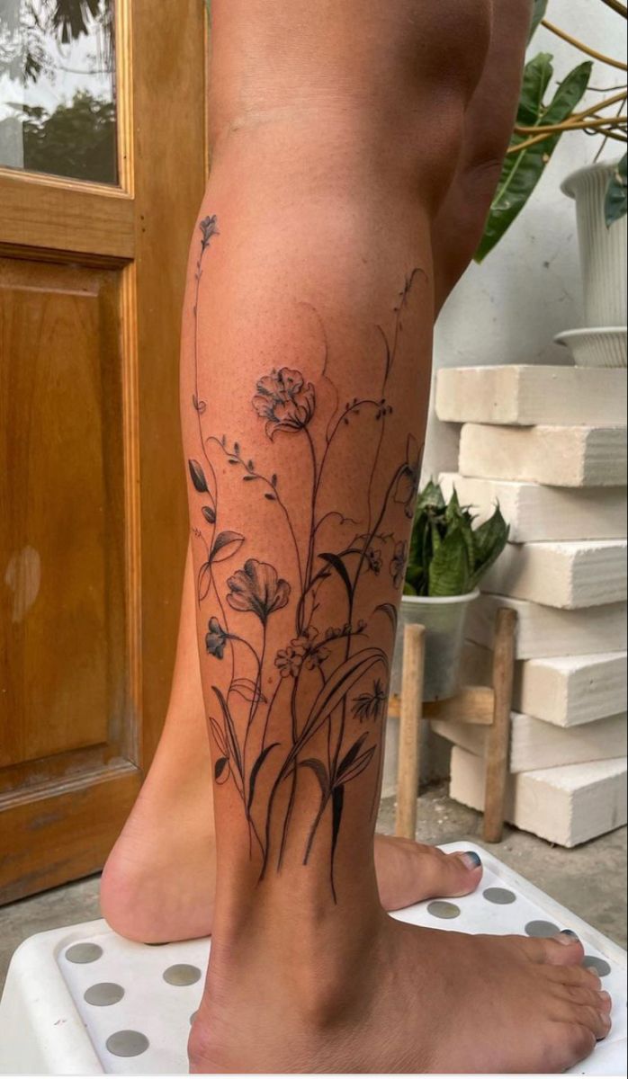 a woman's leg with flowers on it