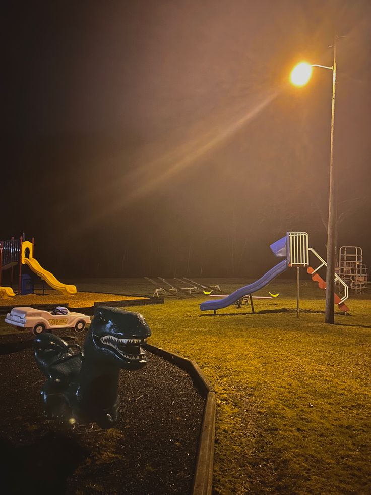 an empty park at night with children's play equipment