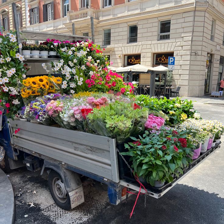 a truck filled with lots of colorful flowers