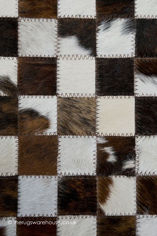 the checkerboard pattern is made up of several different animal furs that are brown, white and black