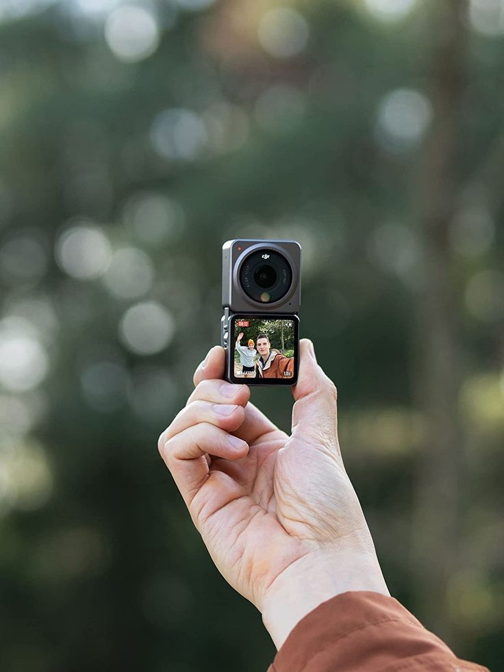 a person holding up a camera to take a photo